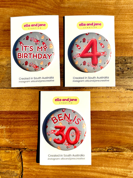 Three firetruck birthday badges. One has the text 'It's my birthday' The other has the number '4' and the third custom badge is 'Ben is 30'.
The backgrounds of the badges are a light rey colour with pictures of flames, fire extinguishers and firetrucks.