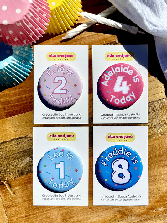 Four birthday party badges. A light pink badge with sprinkles as the background. The Text is in white and pink 'Evie is 2 Today'. A medium pink badge with sprinkles as the background. The text is in white and pink 'Adelaide is 4 Today'. A light blue birthday badge with sprinkles as the background. Text in white and blue 'Leo is 1 Today' and a medium blue birthday badge with sprinkles in the background. The text is 'Freddie is 8' in white and dark blue. 